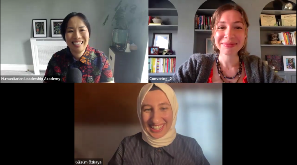 Three women smiling in a virtual meeting discuss, 
