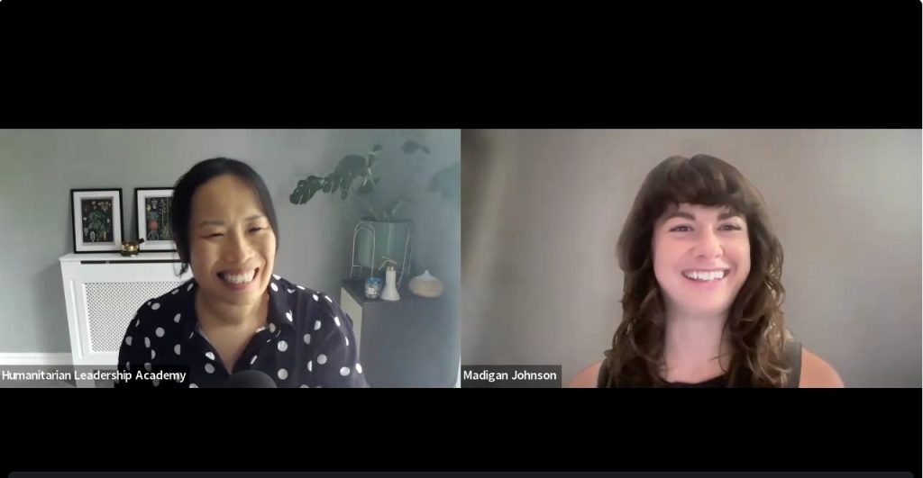Two women smiling during a virtual video call. The woman on the left wears a black shirt with white polka dots, and the woman on the right has long brown hair. Their names, Humanitarian Leadership Academy and Madigan Johnson, are shown.