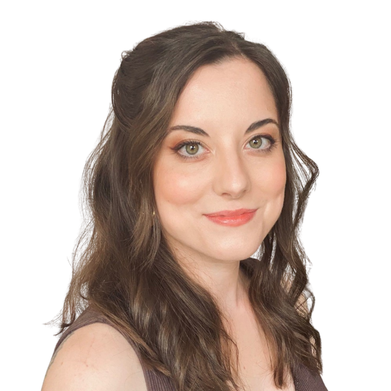 Woman with wavy brown hair and light makeup smiles at the camera, wearing a sleeveless top, against a plain white background.